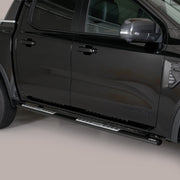 A black pickup truck shown from a side-rear angle, featuring silver metal running boards mounted along the side of the vehicle.